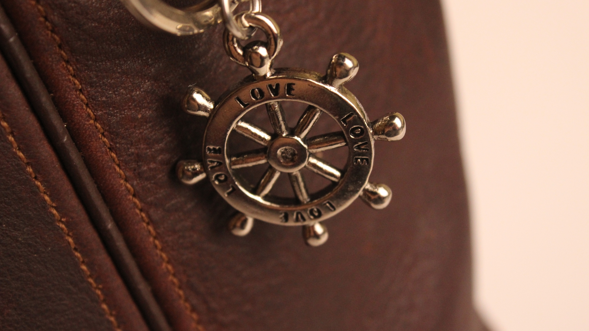 Custom rudder-shaped badge applied to a leather accessory